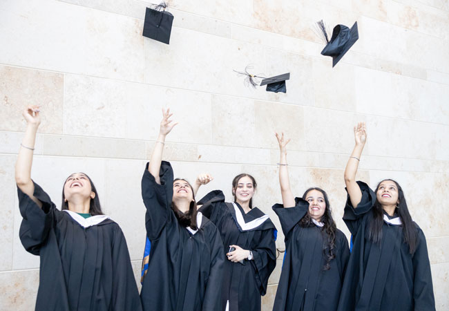 Grads throwing caps