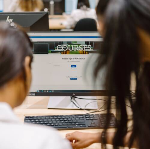 Students looking at laptop screen