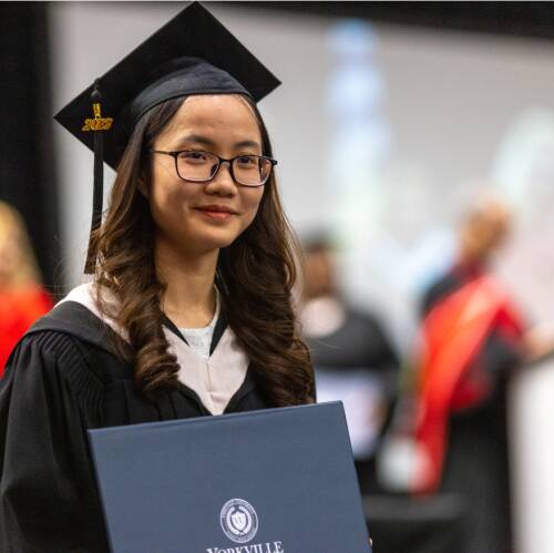 Graduate holding diploma