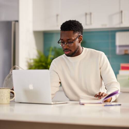 Graduate student at desk with laptop